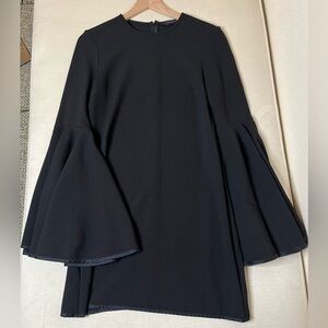 Ellery black dress with statement bell sleeves and quiet luxury energy aesthetic